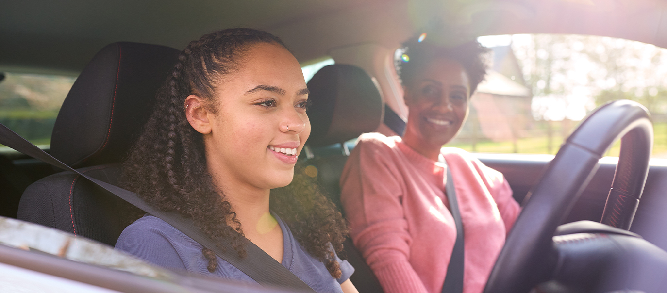 Parent teaching child to drive