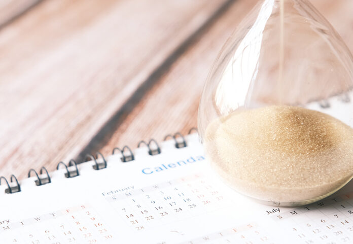 adinjc-driving-test-backlogs-featured Hourglass and calendar